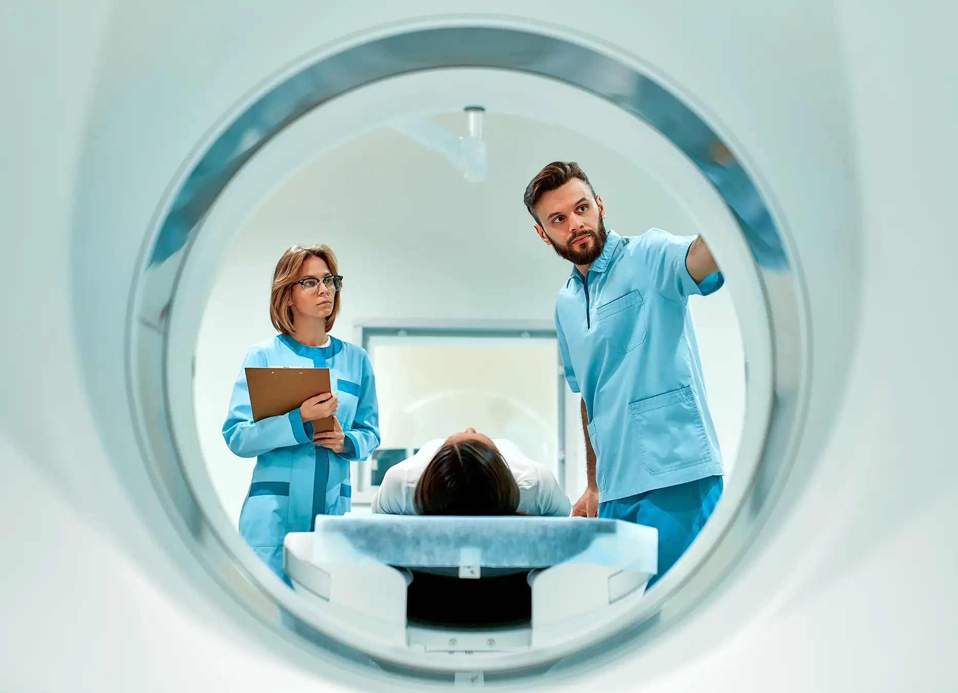 AdobeStock_425084473 (1) copy The patient lies on CT or MRI, the bed is moved inside the machine, scanning her body and brain