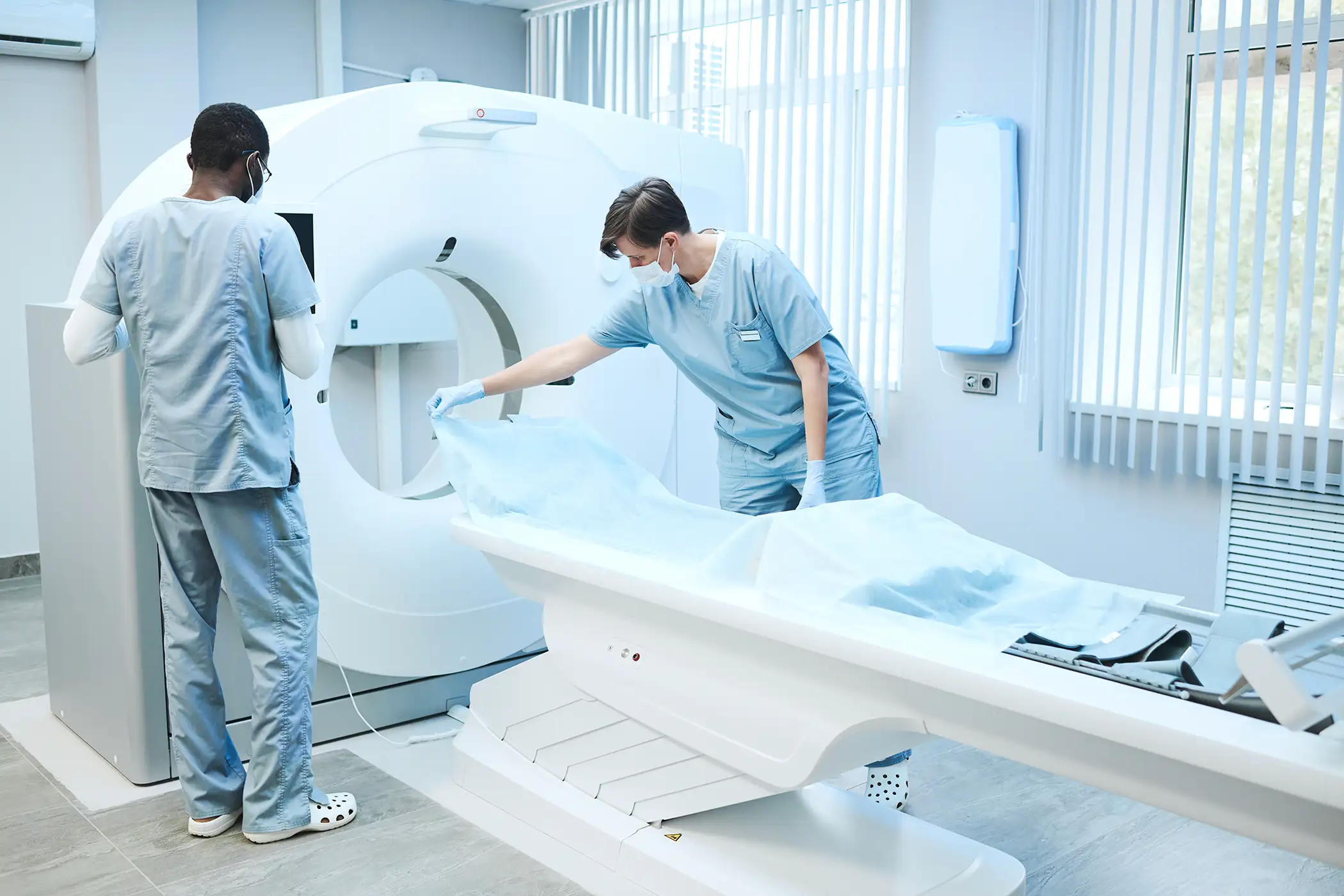 AdobeStock_500188470 copy Medical Team Reviewing Documents and Assisting Patients in a Well-Organized Modern Clinic